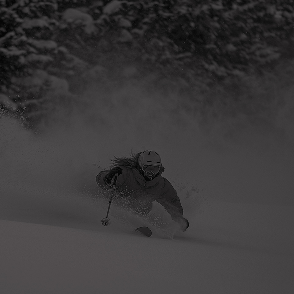 skier smiling while deep in powder